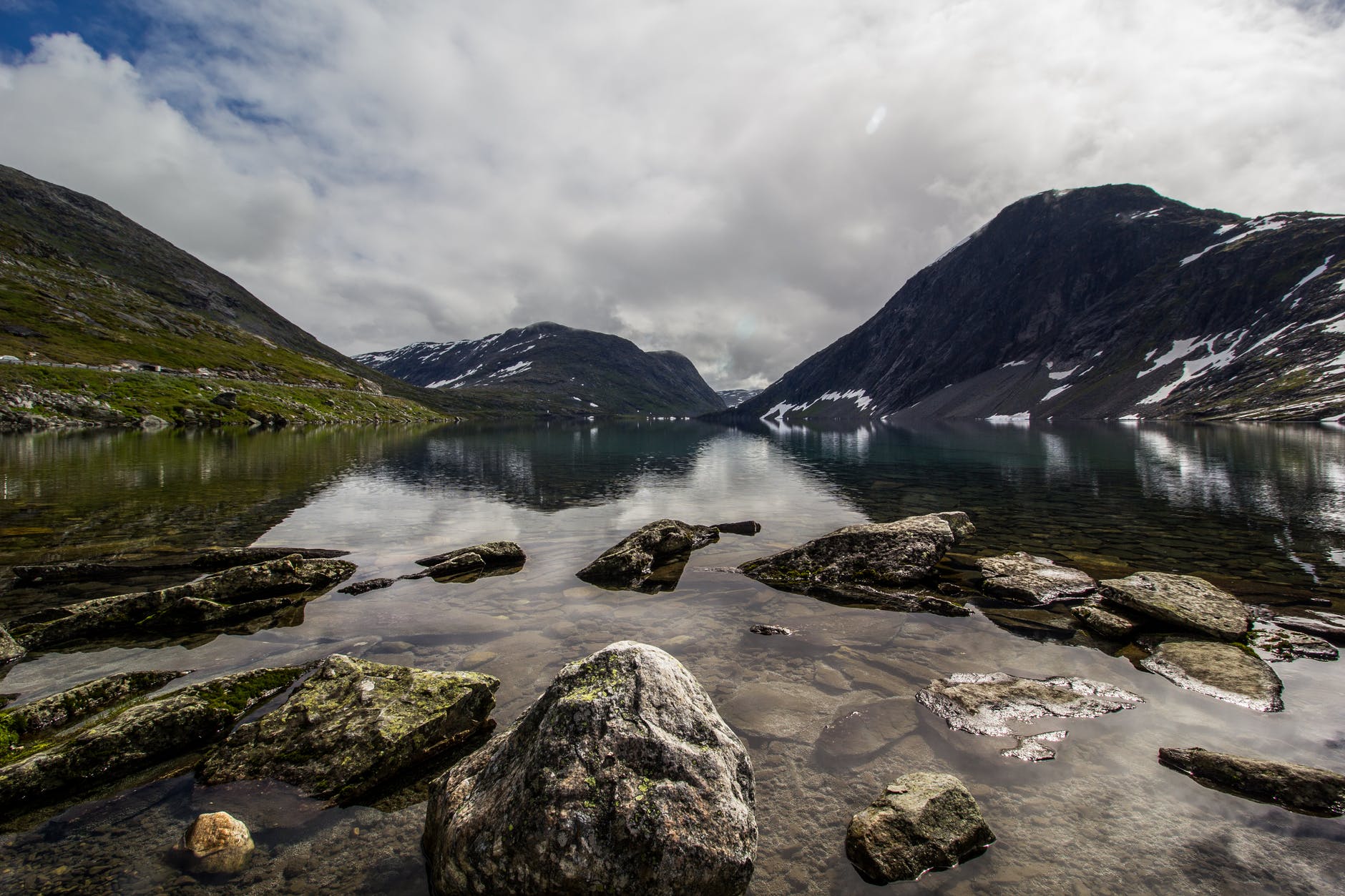 rocks in river and clouds mountains